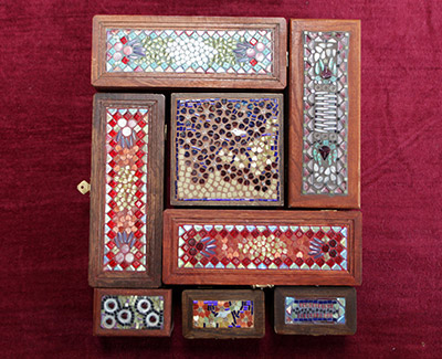 An array of mosaic topped boxes.
