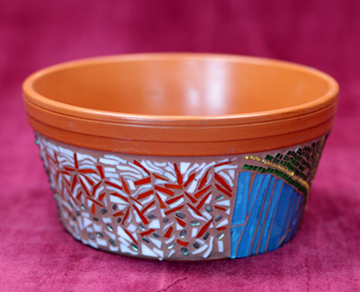 Mosaic decorated pot of plants.